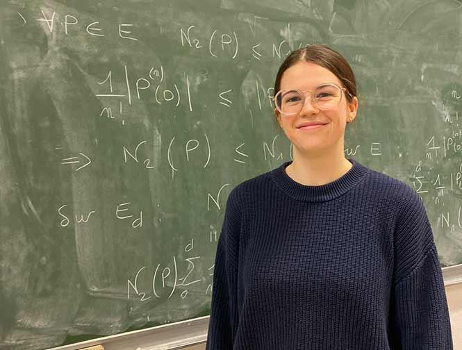 Maëline prépare les concours d'entrée en école d'ingénieurs à l'université Maëline, devant un tableau rempli d'équations