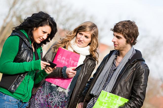 Trois jeunes discutent dehors